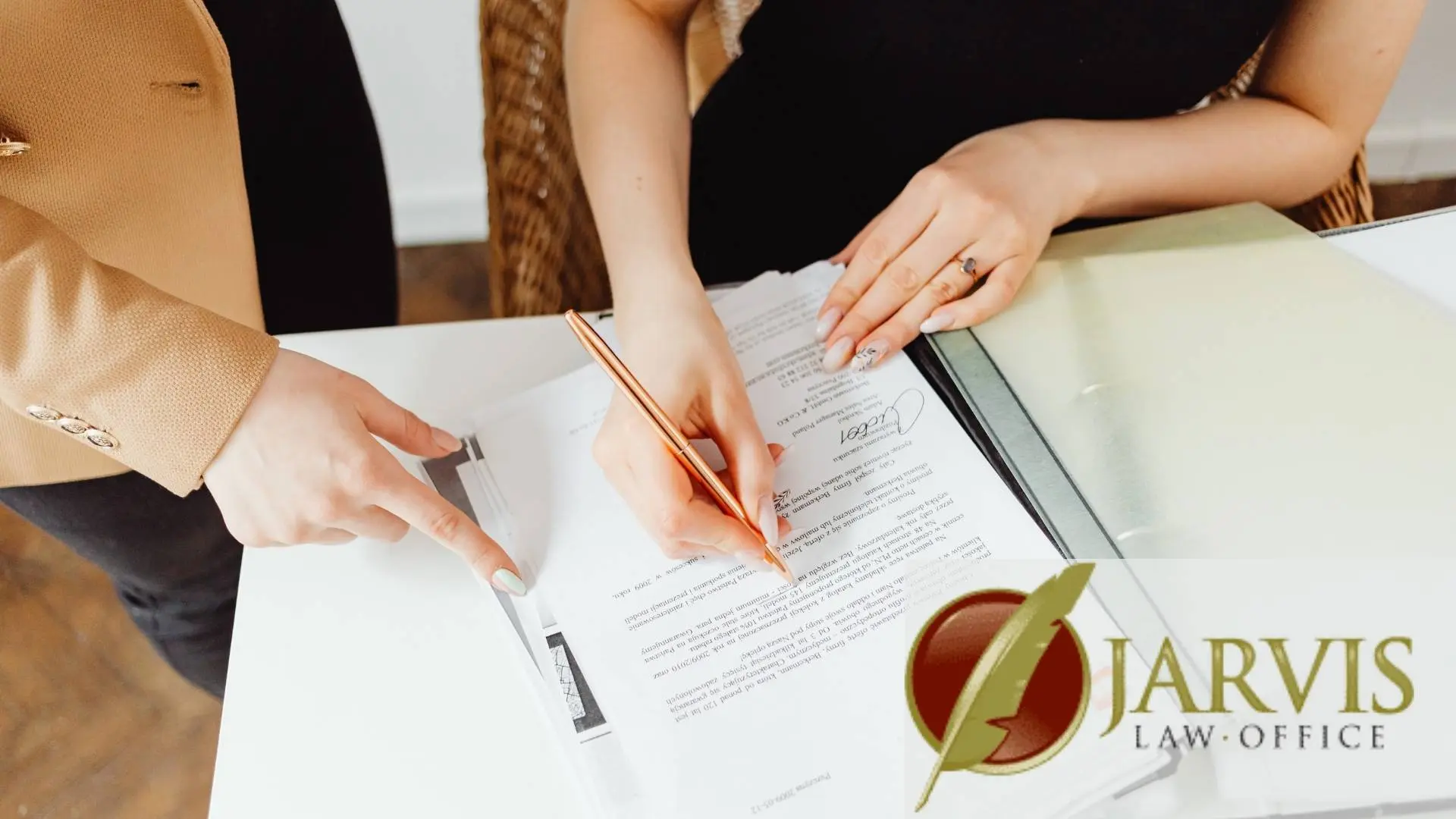 Clients signing legal documents at law office desk