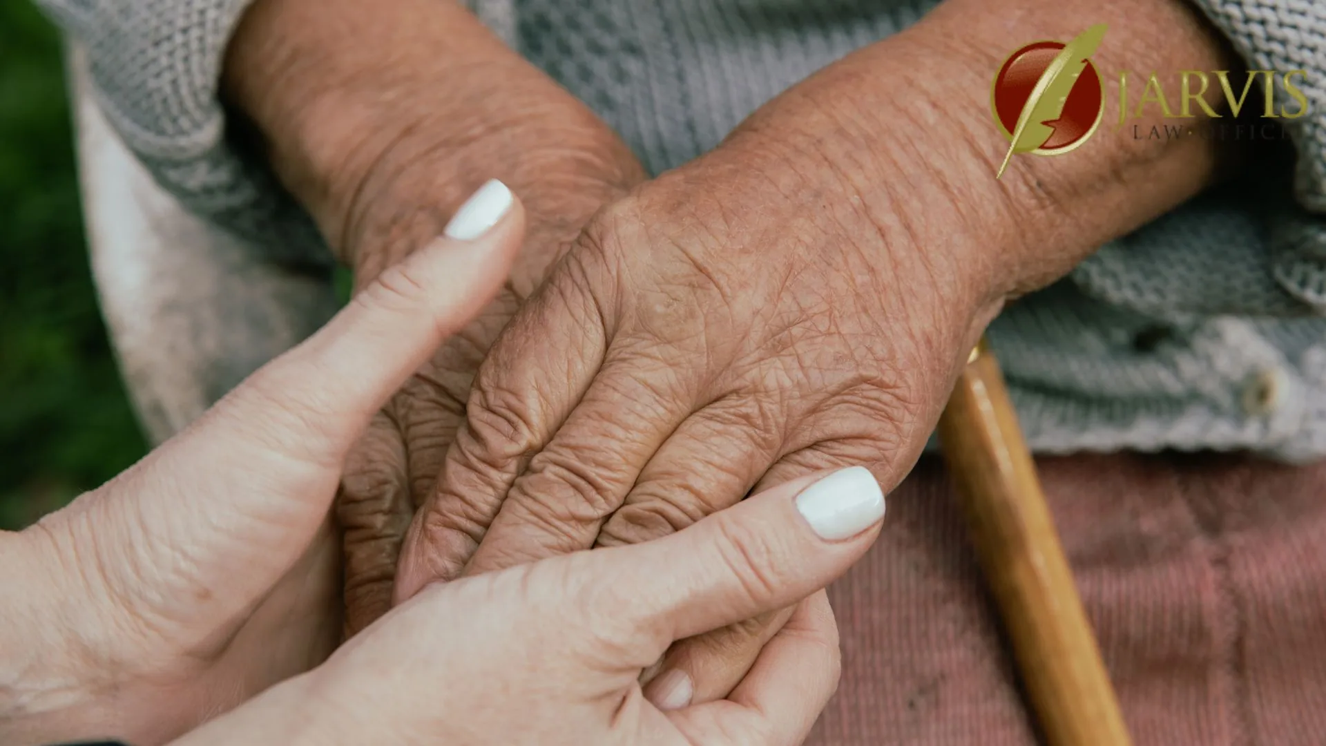 Younger person holding elderly person's hand
