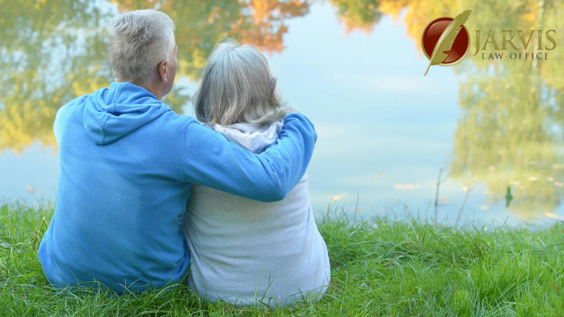 Elderly couple sitting by peaceful lakeside