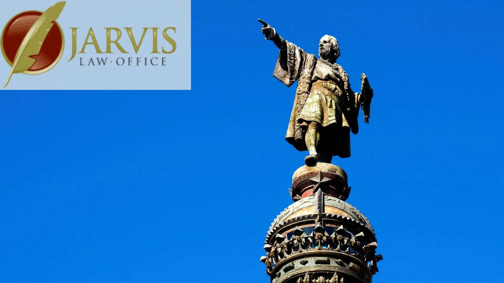 Statue atop ornate column under clear blue sky