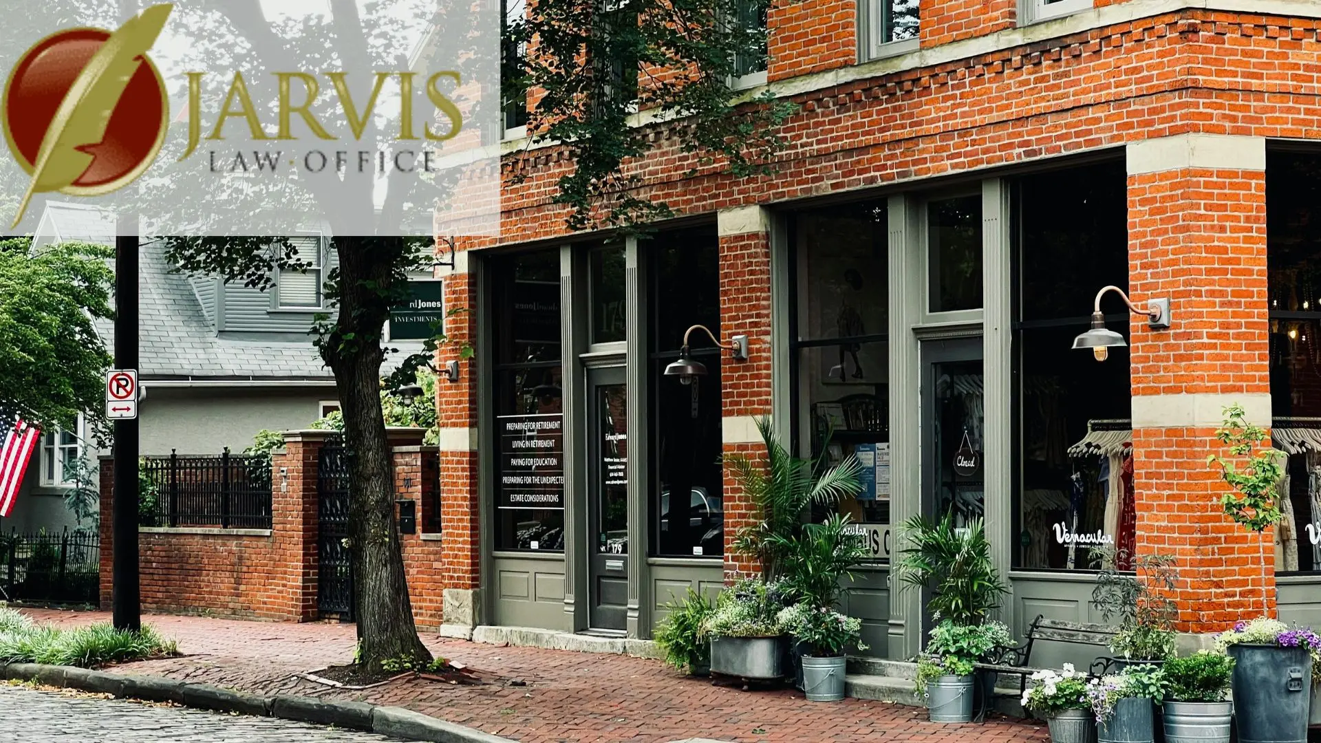 Brick storefront with potted plants and law office logo
