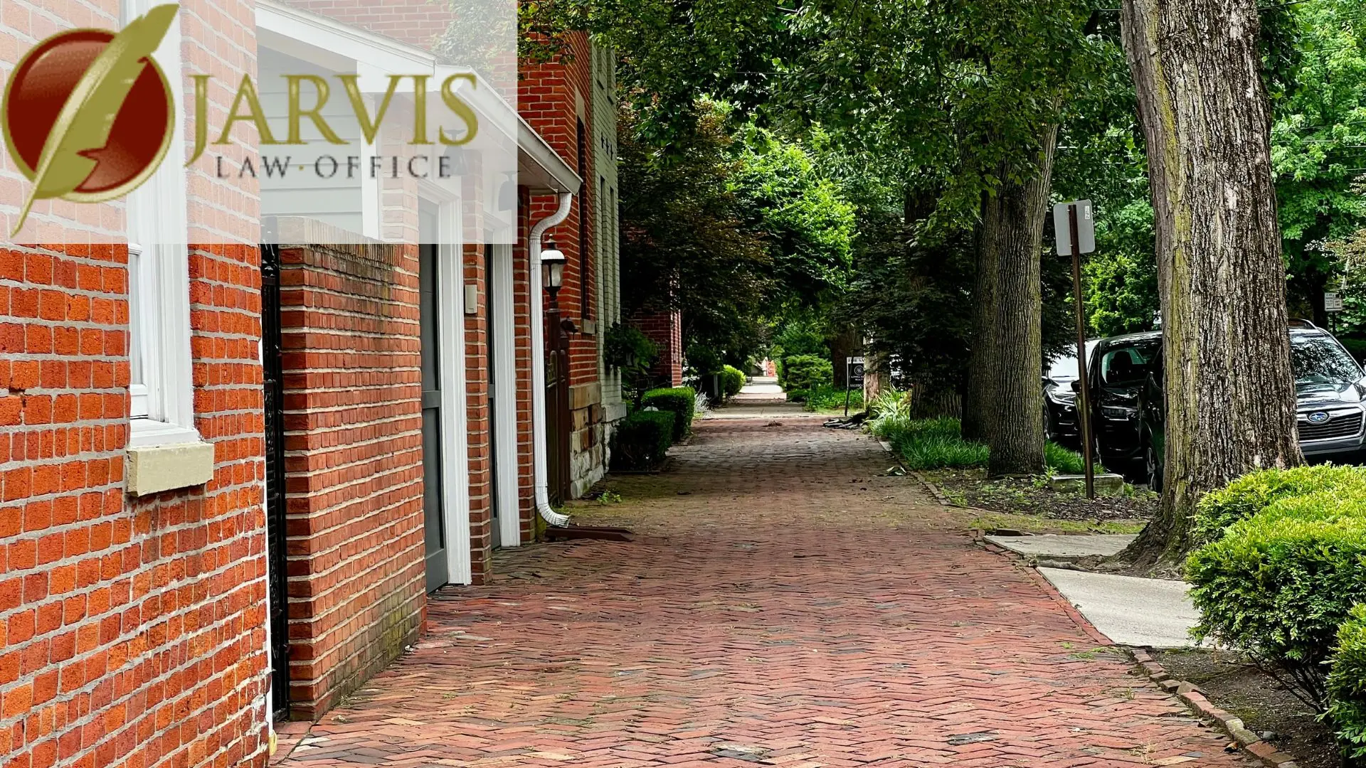Brick sidewalk beside red brick law office