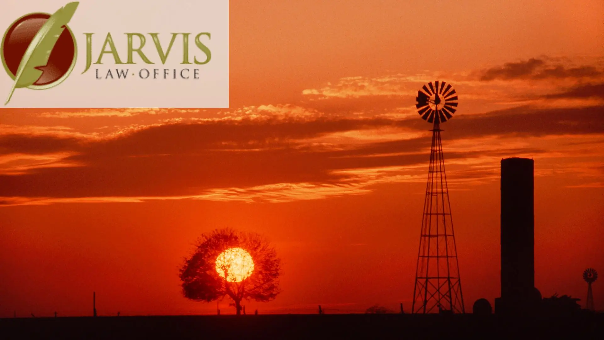 Sunset behind tree and windmill silhouette