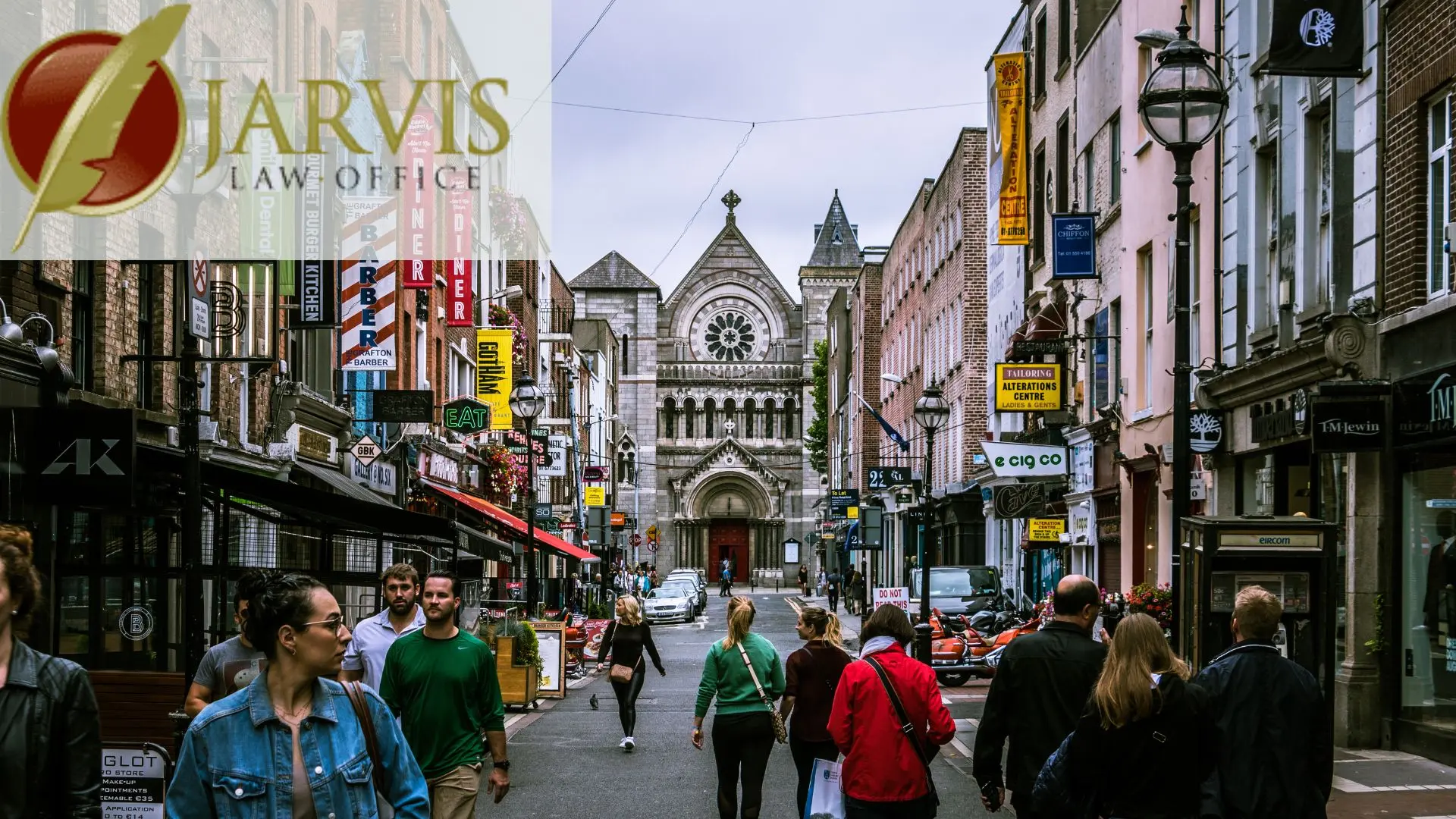 Busy city street with shops and historic church