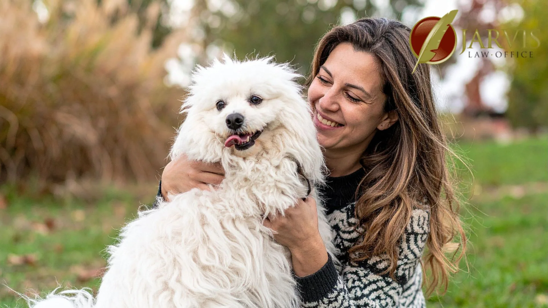 Woman holding fluffy white dog in park