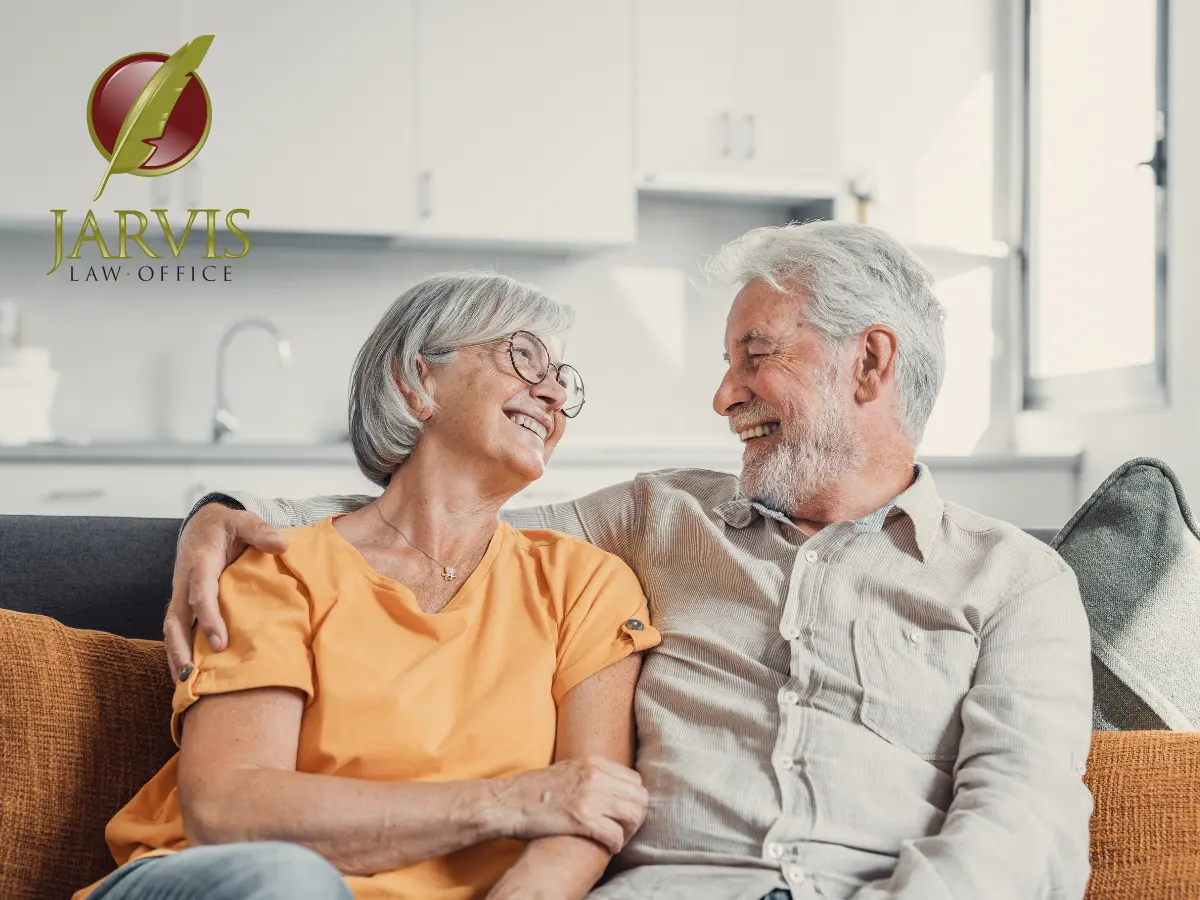 Smiling couple sitting on a sofa together.