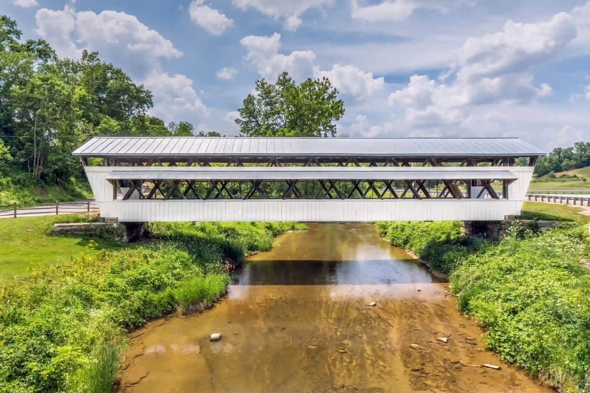 Historic covered bridge over a serene river in lancaster, ohio.