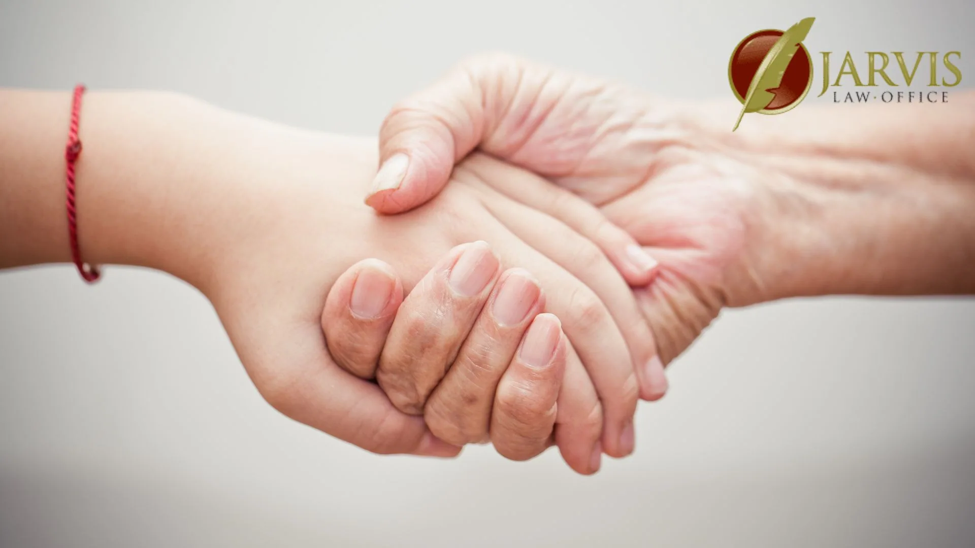 Older and younger hands gently holding