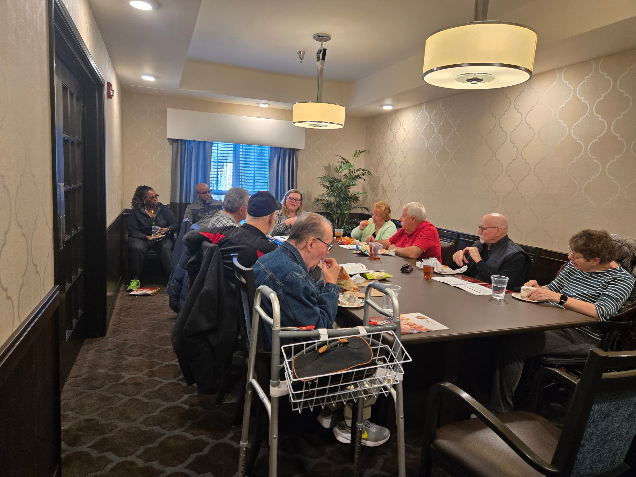 Group meeting in conference room with snacks.