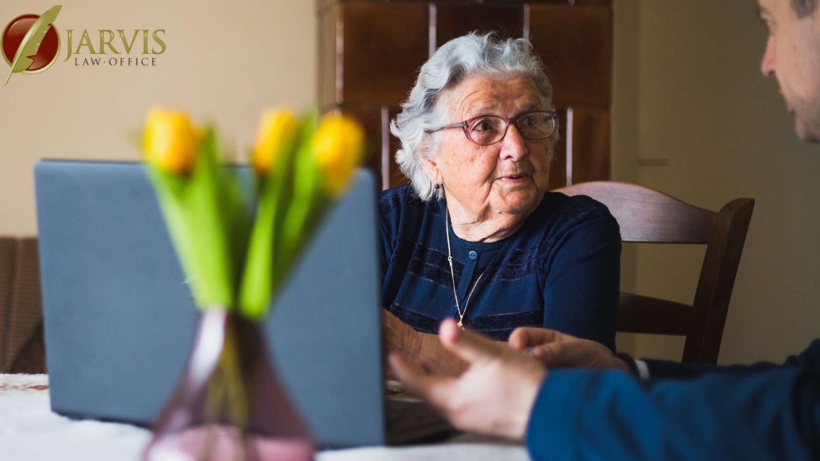 Elderly woman consulting with younger person in office.