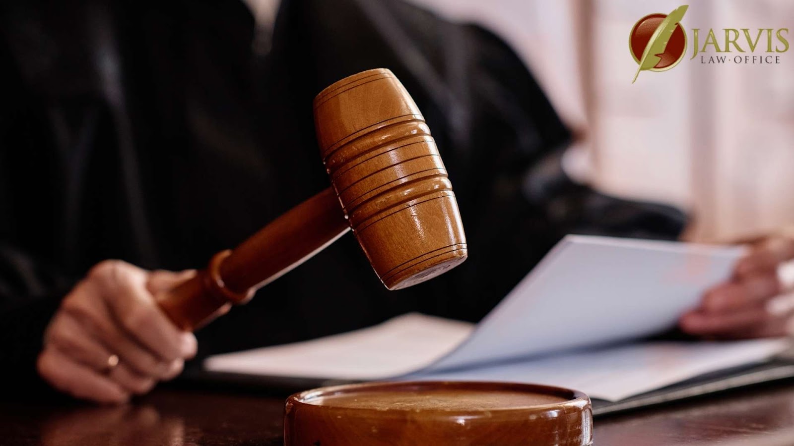 Judge holding gavel in courtroom.