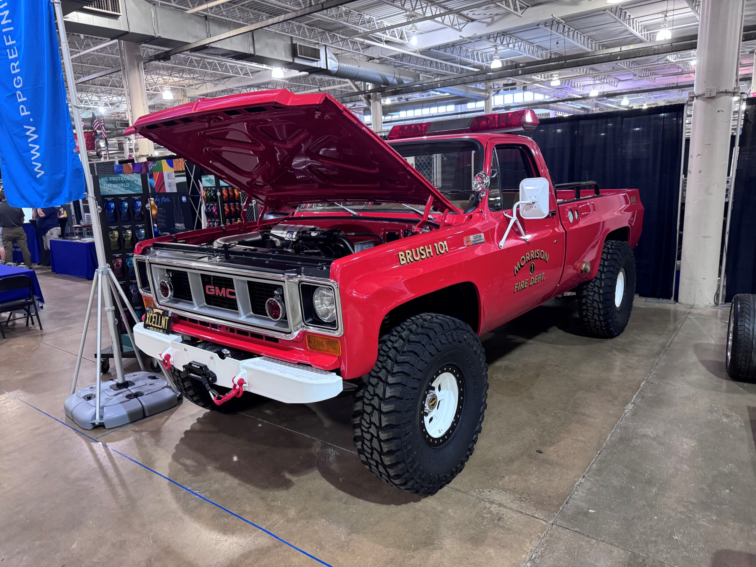 Red vintage fire truck on display indoors.