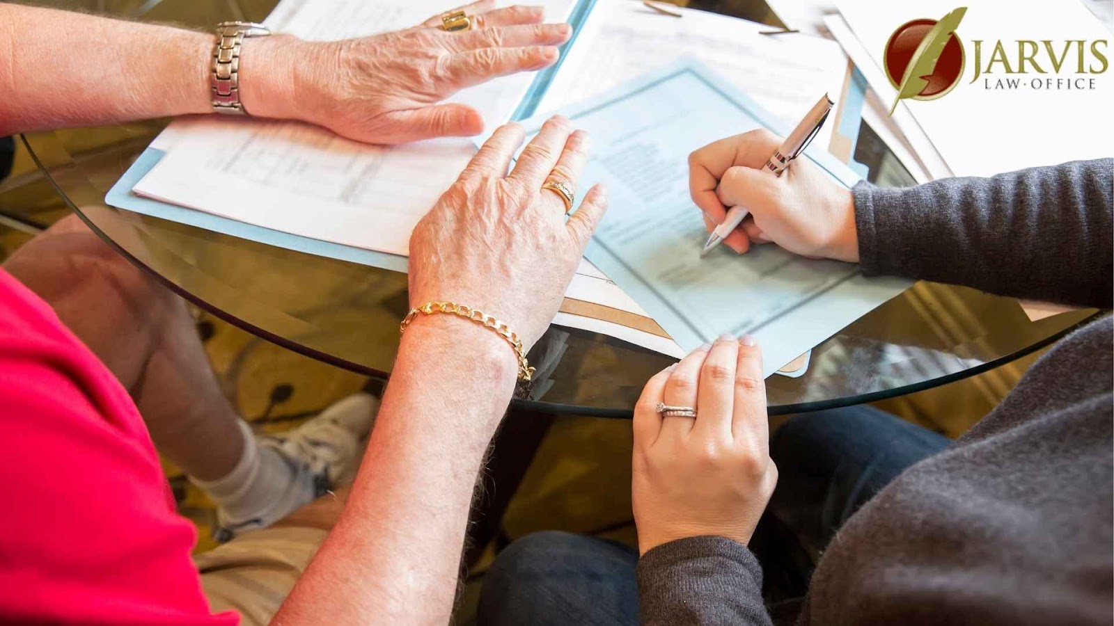 Two individuals signing legal documents at a table.