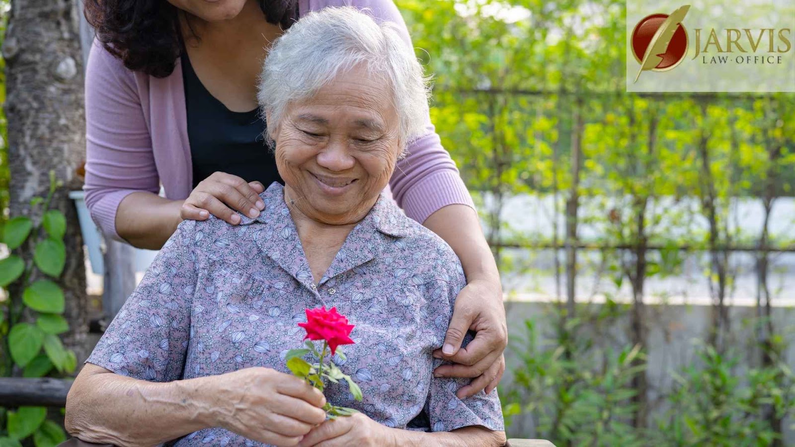Elderly woman holding a red rose, smiling.