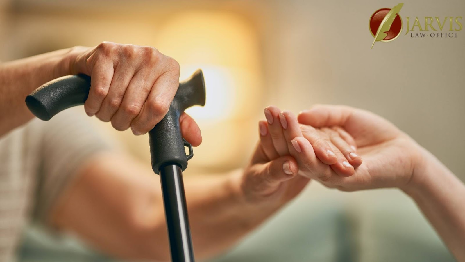Elderly hand with cane held by caregiver.