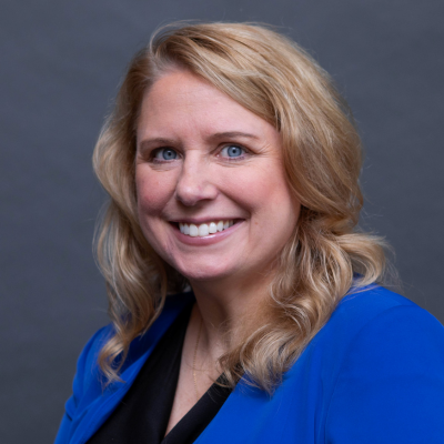 Smiling woman in blue blazer portrait.