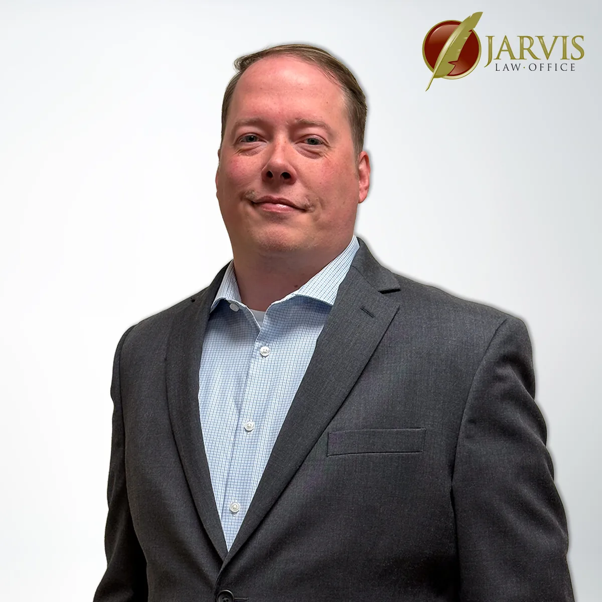 Man in suit, Jarvis Law Office logo visible.