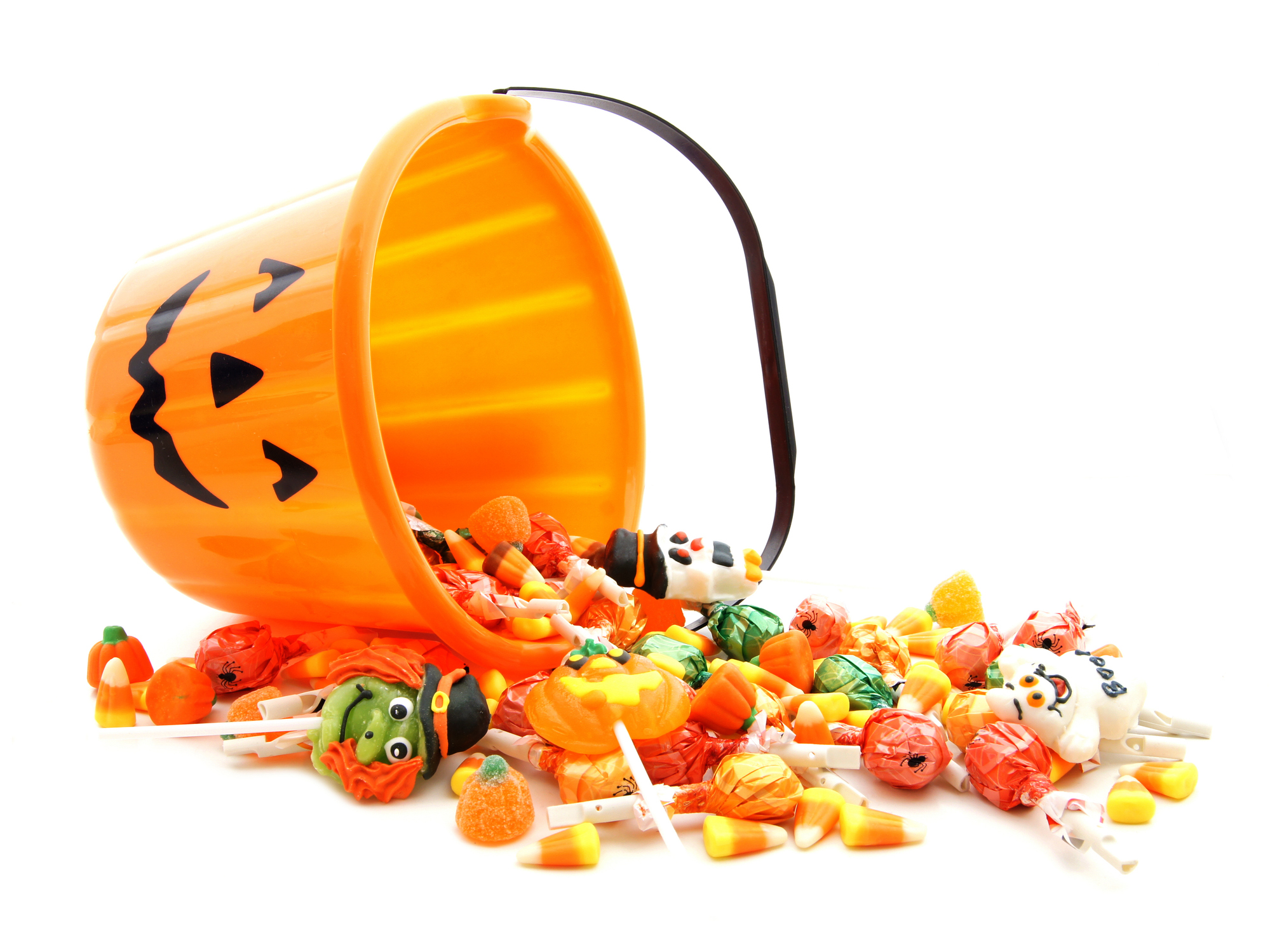 Halloween candy spilling from pumpkin bucket