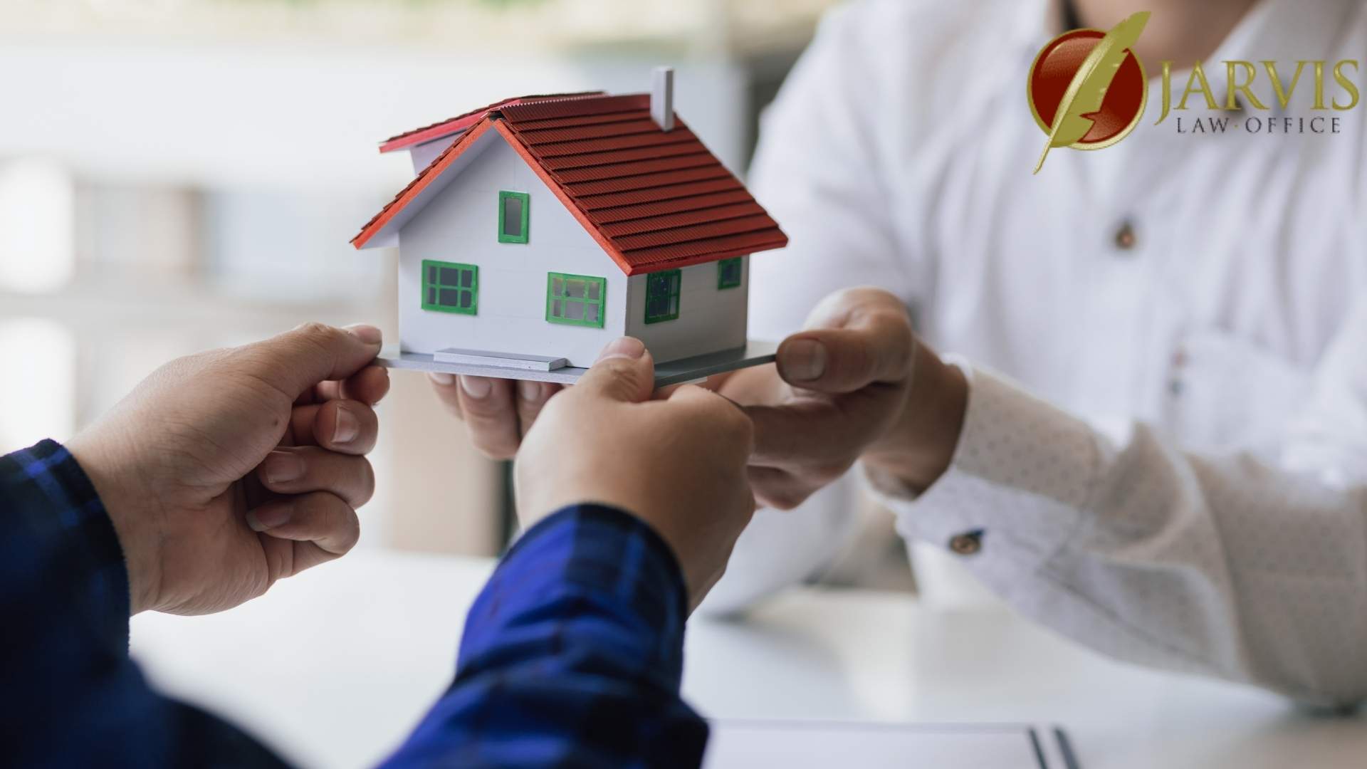 People exchanging a small house model representing inheritance protection