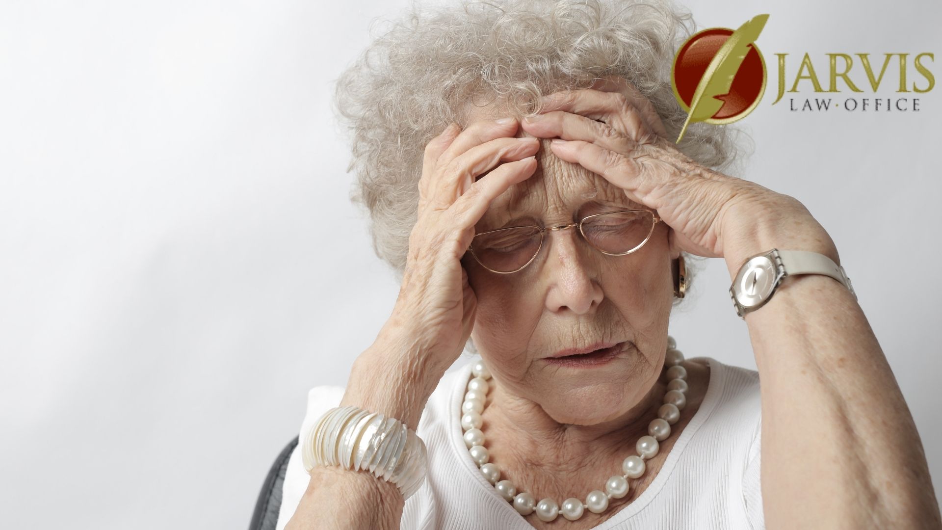 Stressed elderly woman holding her head