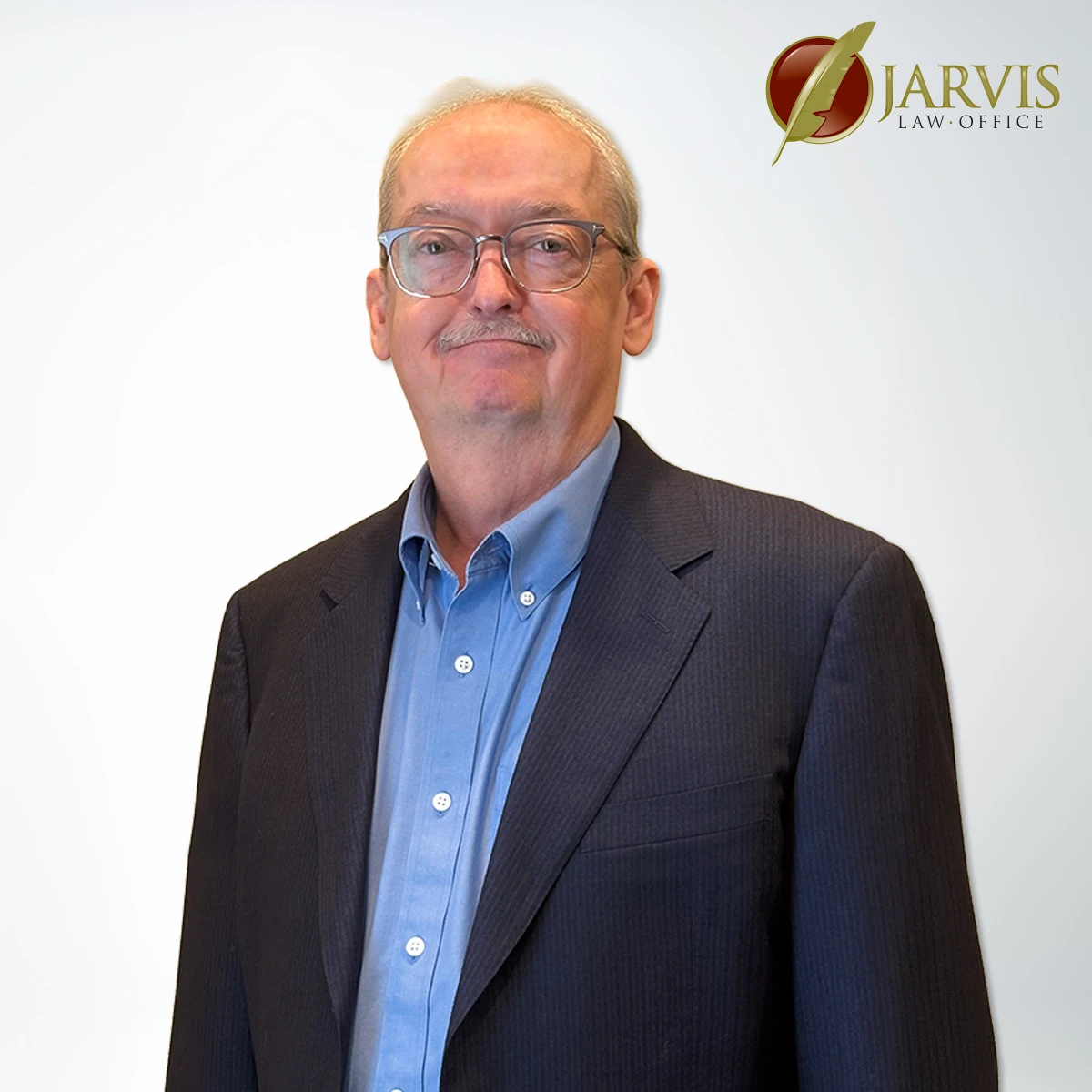 Man in suit with Jarvis Law Office logo