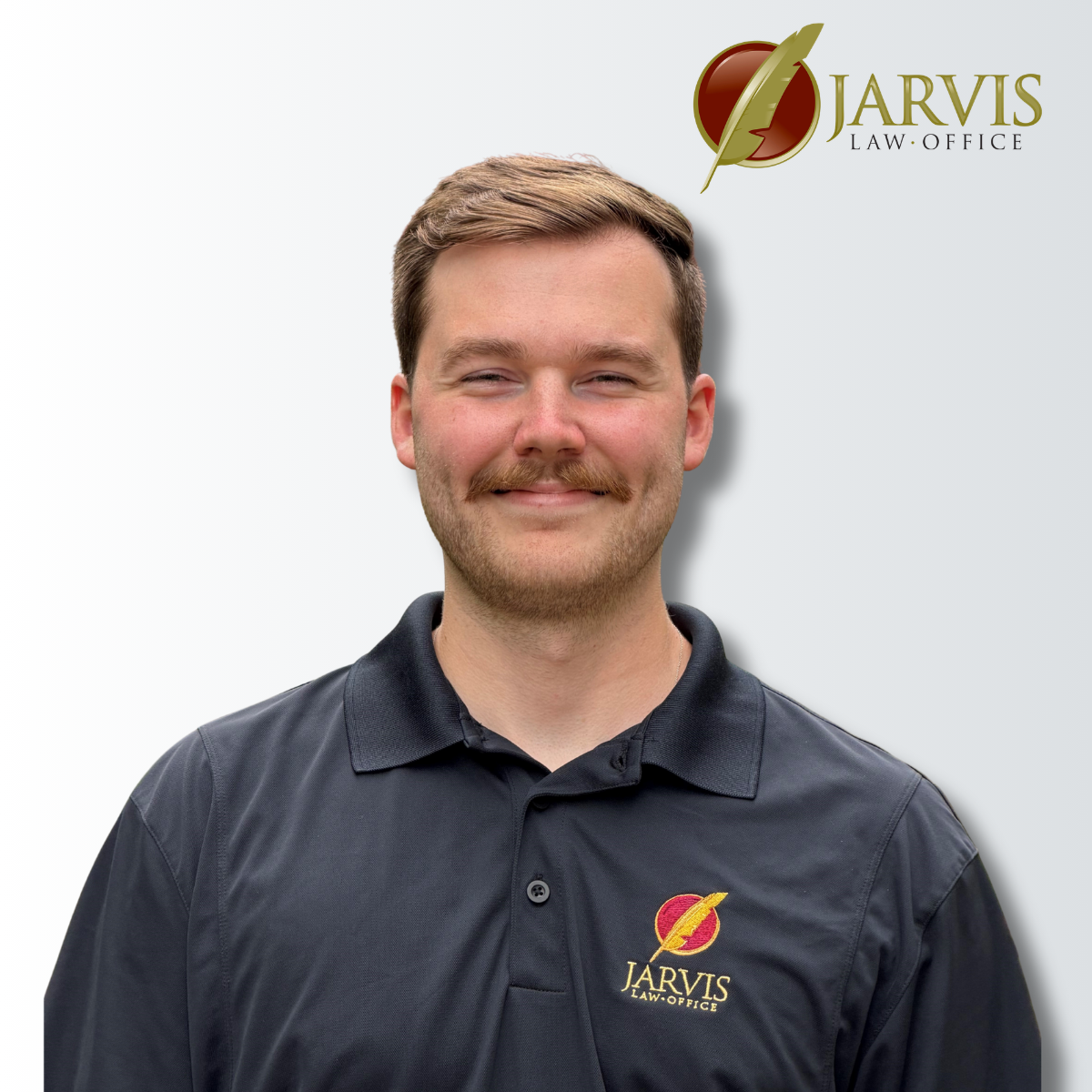 Man wearing Jarvis Law Office polo shirt
