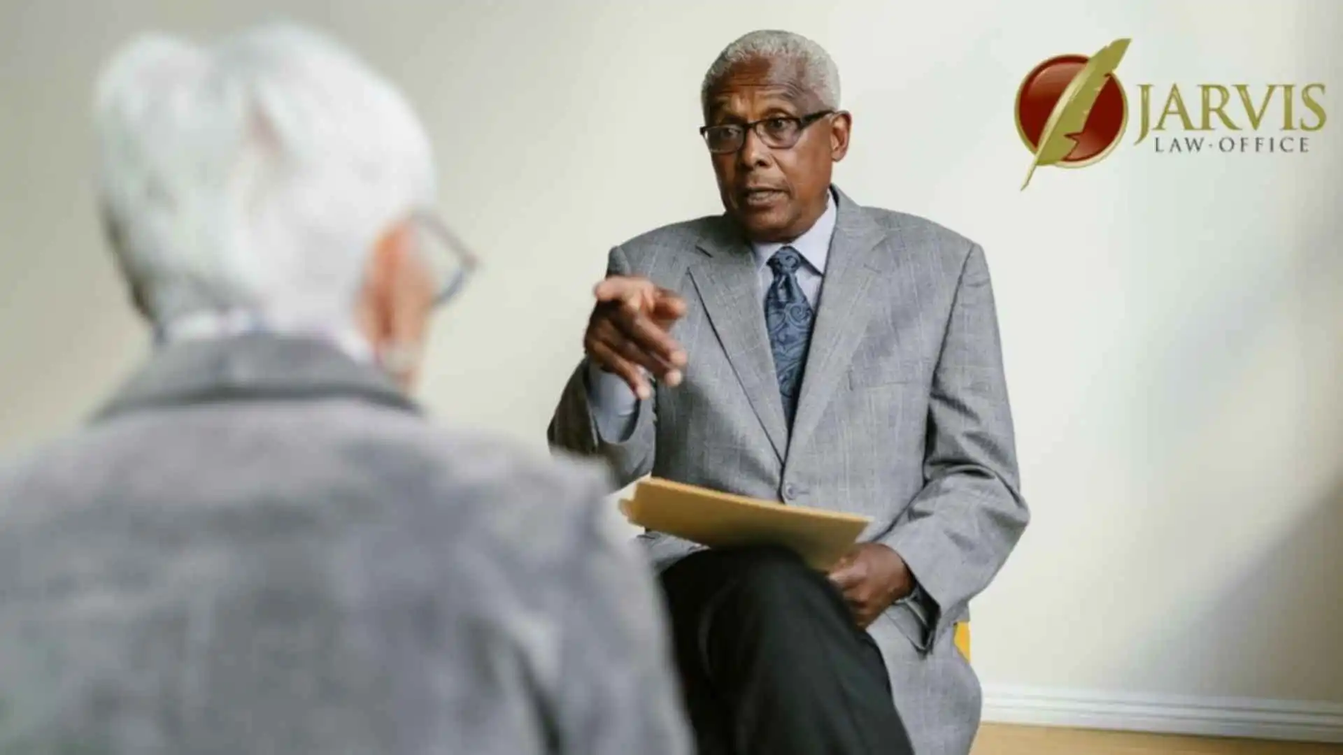 Two senior adults in a business meeting indoors, discussing important matters, illustrating elder law attorney in Parkesburg. Branded with the Jarvis Law Office, P.C. logo.